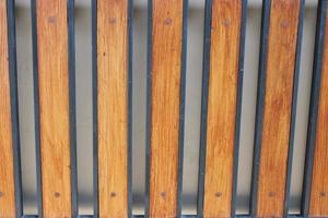 Photo of a symmetrical brown and black iron picket fence