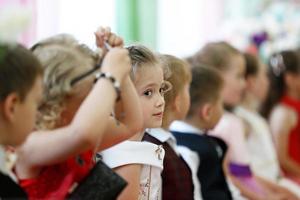 Child preschooler in the ranks of children. photo