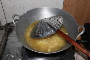 the pan is frying the potatoes on the stove photo