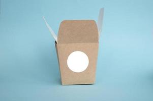 Round sticker mockup on open kraft box, lunch box, packaging with blank sticker, adhesive label photo