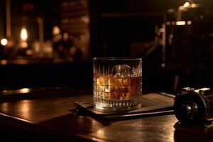 Rich whiskey in a glass, poised elegantly on a wooden table. photo