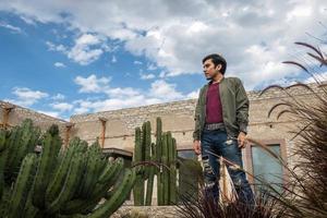 Man visiting the old rustic model school with cactus in Mineral de Pozos Guanajuato Mexico photo