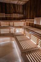 Interior of empty finnish sauna room with wooden wall and benches photo