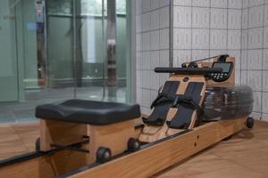 Rowing machine on hardwood floor in exercise room at luxury hotel photo