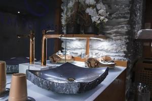 Closeup of modern sink with faucet in bathroom at hotel photo