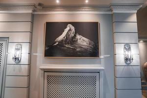 Picture frame of mountain mounted on wall in luxury resort photo