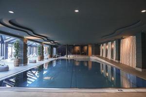 Swimming pool located in center luxury hotel room photo