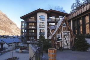 Exterior of hotel building and wooden cottage at Zermatt photo