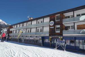 Ski resort at snow covered mountain in front of clear sky photo