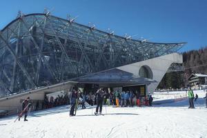 Tourists outside ski resort during winter vacation photo