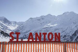 St Anton text in front of snow covered mountain photo
