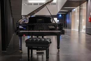 Piano with black stool displayed as decoration in luxury resort photo