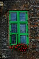 interesting windows in old historic tenement houses in the Polish city of Gdansk close up photo