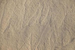 original background of golden sand in the dunes on a sunny day photo