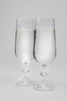 two glasses with champagne on a white background photo