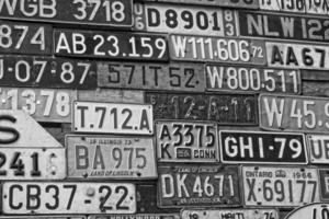 Various old car license plates from around the world at the museum photo