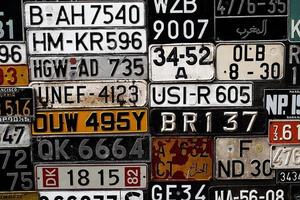 Various old car license plates from around the world at the museum photo