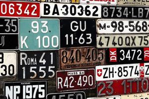 Various old car license plates from around the world at the museum photo