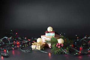 Christmas gifts with a branch of a Christmas tree. Glowing garland. Christmas. New year photo