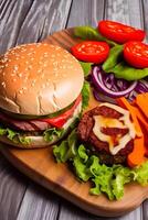 A hamburger with a tomato on it and a salad on the side. photo