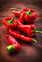 Red peppers on a wooden table photo