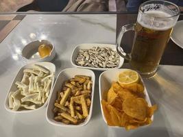 Snacks and beer on the table in a pub. Close up photo