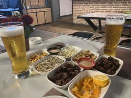 Snacks and beer on the table in a pub. Close up photo