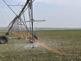 Irrigation system watering the field with a high pressure water jet photo