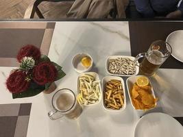 Snacks and beer on the table in a pub. Close up photo