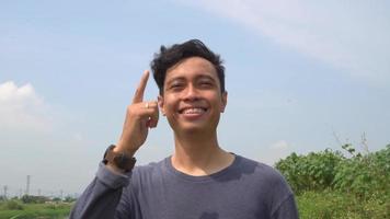 Young man Indonesia think expression on day light with nature sky background. The footage is suitable to use for advertising and expression content media. video