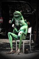 statue of green frogs drinking turkish tea in the city photo