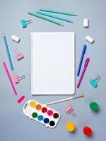 Top view of a flat work desk lies a notebook with blank sheets and stationery. Template for women's blogs in social networks photo