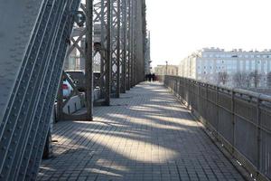 Railroad bridge with symmetrical metal structure and tracks. photo