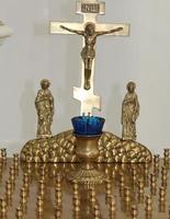 Christians light candles in front of the Orthodox cross with the crucifix, the concept of Orthodox faith and religion. photo