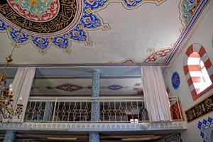 modest simple interior of a small Turkish village mosque with one miner photo