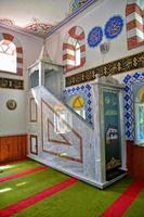 modest simple interior of a small Turkish village mosque with one miner photo