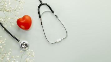 Heart love shape ball with stethoscope on blue background with copy space photo