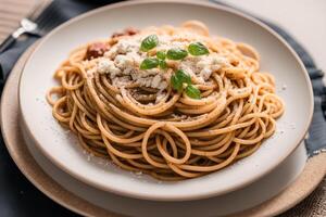 Spaghetti pasta with parmesan cheese and parsley on a plate. photo
