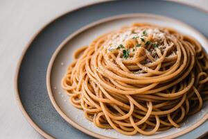 Spaghetti pasta with parmesan cheese and parsley on a plate. photo