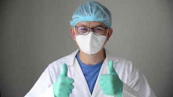 asiatisch Arzt zeigt an Daumen oben Zeichen ausdrücken gut Ergebnis von medizinisch Prozesse video