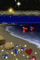 couple of hearts sitting on top of a sandy beach. . photo