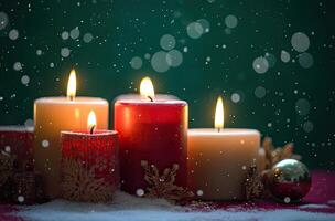 Burning candle and Christmas decoration over snow and wooden background. . photo