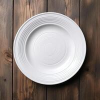 An empty plate on a white wooden table. Top view of white ceramic plate on white wooden. . photo