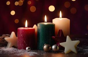 Burning candle and Christmas decoration over snow and wooden background. . photo