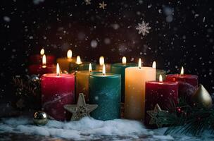 Burning candle and Christmas decoration over snow and wooden background. . photo