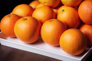 Ripe orange fruit with leaves on wooden table, closeup view. photo