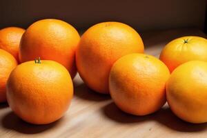 Ripe orange fruit with leaves on wooden table, closeup view. photo