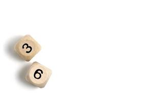 Pair of wooden dice for board games with numbers three and six white background. photo