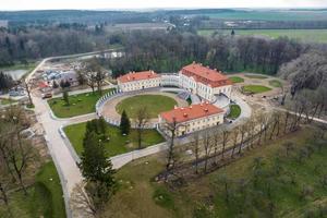 aerial view on overlooking restoration of the historic castle or palace near lake photo