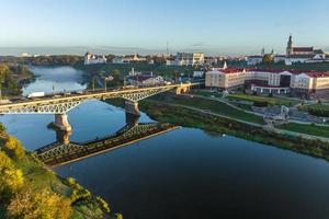 aerial view from great height on wide river and huge bridge of old city photo